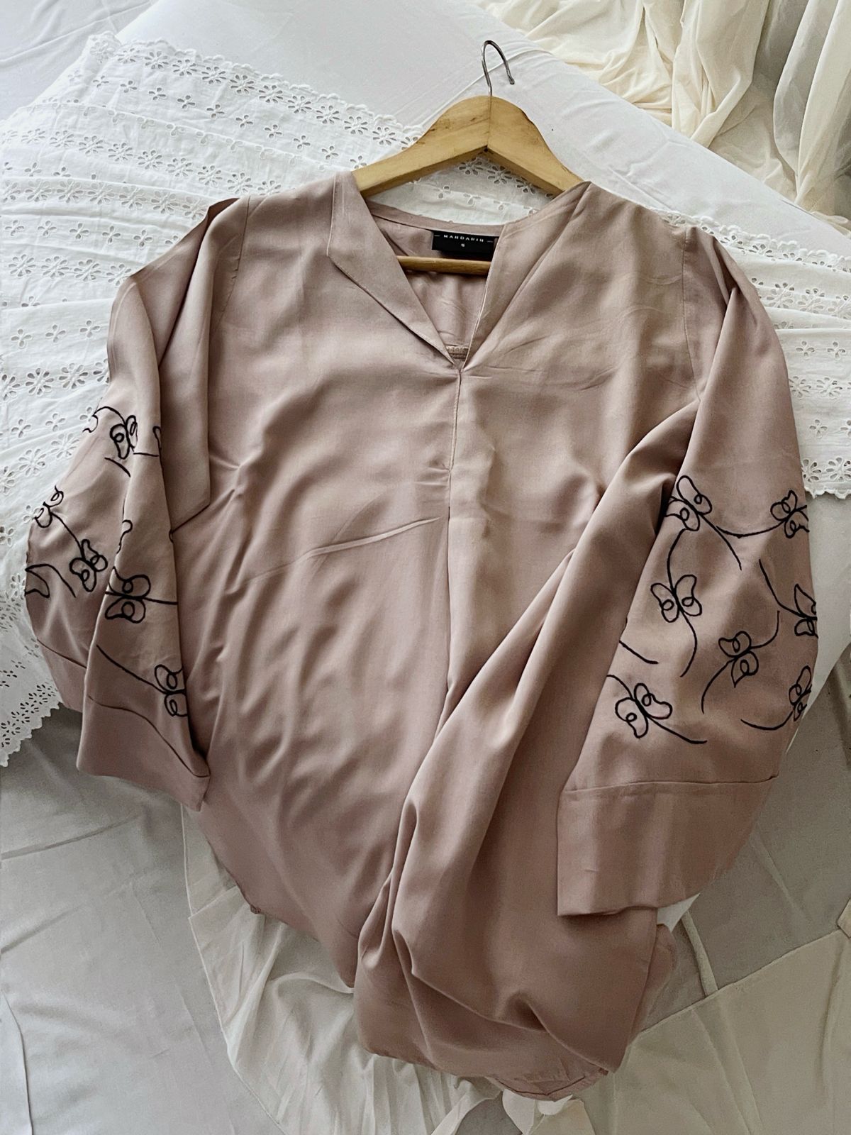 Nude top with black embroidery detail