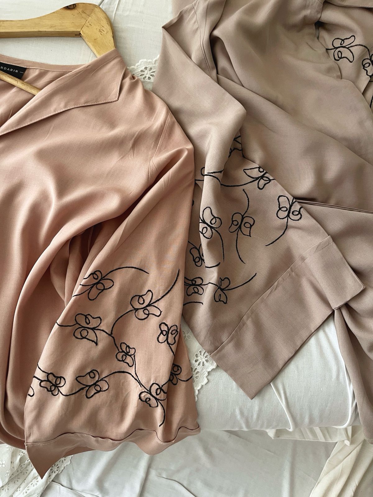 Nude top with black embroidery detail