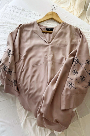 Nude top with black embroidery detail